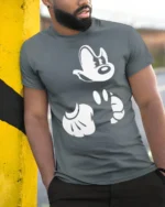 Retro Cartoon Gloves and Face Minimal Graphic T Shirt - model wearing grey tee, leaning on column