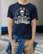 Funny It Is What It Is Skeleton Vintage Graphic T Shirt - model wearing navy tee with hands in pockets