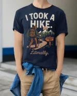 Retro Hiking Joke I Took A Hike Literally Nature Graphic Tee - model wearing navy tee with hands in pockets