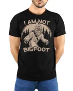 Funny I Am Not Bigfoot Sasquatch Vintage Graphic T Shirt - model wearing black tee with hands behind back