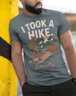 Retro Hiking Joke I Took A Hike Literally Nature Graphic Tee - model wearing grey tee, leaning on column