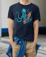 Cool Octopus Surfboard Beach Wave Graphic Tee Design - model wearing navy tee with hands in pockets