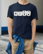 Risk Dice Game Funny Wordplay Chance Humor Graphic Tee - model wearing navy tee with hands in pockets