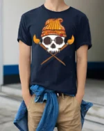 Artistic Skull With Paint Brushes Creative Graphic T Shirt - model wearing navy tee with hands in pockets
