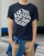 Ask Trust God Thank God Christian Faith Typography Tee - model wearing navy tee with hands in pockets