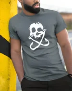Skull Fishing Hooks Pirate Style Funny Graphic Tee - model wearing grey tee, leaning on column
