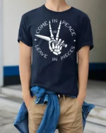 Come In Peace Or Leave In Pieces Skull Hand Graphic T Shirt - model wearing navy tee with hands in pockets