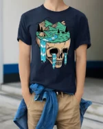 Surreal Skull Mountain Landscape Graphic T Shirt Nature Art Tee - model wearing navy tee with hands in pockets