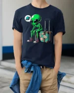 Funny Traveling Alien With Suitcase Graphic T Shirt Space Humor - model wearing navy tee with hands in pockets