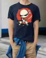 Cartoon Ninja Fighter Graphic T Shirt Cute Warrior Style Design - model wearing navy tee with hands in pockets