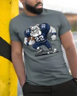 Cool Bulldog Running Football Graphic T Shirt Athletic Cartoon Tee - model wearing grey tee, leaning on column