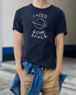 I Need Some Space Funny Planet Minimalist Graphic T Shirt - model wearing navy tee with hands in pockets