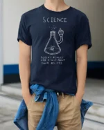 Funny Science Doesn’t Care About Your Beliefs Graphic T Shirt - model wearing navy tee with hands in pockets