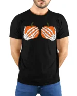Funny Skeleton Hands Holding Pumpkins Halloween Spooky Graphic T Shirt - model wearing black tee with hands behind back