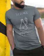 Funny Science Doesn’t Care About Your Beliefs Graphic T Shirt - model wearing grey tee, leaning on column