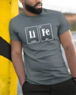 LiFe Chemistry Pun Lithium Iron Periodic Table Funny T Shirt - model wearing grey tee, leaning on column