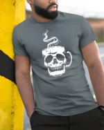 Cool Skull Coffee Lover Graphic T Shirt Minimalist Design - model wearing grey tee, leaning on column