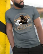 Colorado Adventure Awaits Bear Mountain Vintage Graphic T Shirt - model wearing grey tee, leaning on column