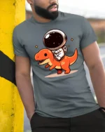 Kawaii Space Dino Astronaut Graphic T Shirt Fun Cartoon Tee - model wearing grey tee, leaning on column