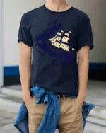 Cosmic Sailing Ship Graphic Tee Space Ocean Fantasy Tshirt - model wearing navy tee with hands in pockets