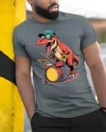 Funny Drummer Dinosaur Graphic Tee Cool Music Dino Tshirt - model wearing grey tee, leaning on column