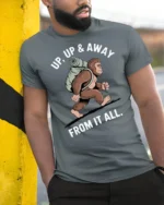 Funny Bigfoot Hiking Graphic Tee Up Up And Away Tshirt - model wearing grey tee, leaning on column