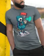 Street Artist Skeleton Graphic Tee Urban Graffiti Style Tshirt - model wearing grey tee, leaning on column