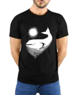 Cosmic Whale Surf Graphic Tee Dreamy Ocean Night Tshirt - model wearing black tee with hands behind back