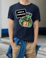 Speed Is Overrated Funny Turtle Tshirt Cute Chill Graphic - model wearing navy tee with hands in pockets