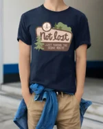 Not Lost Scenic Route Tshirt Funny Travel Adventure Graphic - model wearing navy tee with hands in pockets
