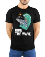 Ride The Wave Skeleton Surfing Whale Tshirt Ocean Humor - model wearing black tee with hands behind back
