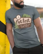 Not Lost Scenic Route Tshirt Funny Travel Adventure Graphic - model wearing grey tee, leaning on column