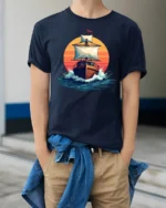 Vintage Sailing Ship Sunset Ocean Graphic Tshirt Adventure Style - model wearing navy tee with hands in pockets