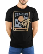 Sunshine And Surf Retro Beach Graphic Tshirt Summer Vibes Style - model wearing black tee with hands behind back