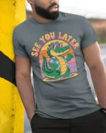 Funny See You Later Alligator Retro Summer Graphic Tshirt Style - model wearing grey tee, leaning on column