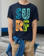 Colorful Surf Typography Beach Summer Retro Graphic Tee - model wearing navy tee with hands in pockets