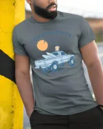 Catch The Waves Surf Truck Beach Adventure Vintage Graphic Tee - model wearing grey tee, leaning on column