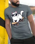 Cool Skateboarding Cat Funny Sunglasses Cartoon Graphic Tee - model wearing grey tee, leaning on column