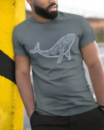 Artistic Tribal Whale Ocean Nature Inspired Graphic Tee - model wearing grey tee, leaning on column