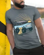 Surf Truck Sunset Dog Beach Adventure Retro Graphic Tee - model wearing grey tee, leaning on column