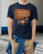 Hit The Trails Hiking Adventure Nature Graphic Tee Tshirt - model wearing navy tee with hands in pockets