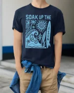 Soak Up The Sun Retro Surf Beach Vibes Graphic Tee Tshirt - model wearing navy tee with hands in pockets