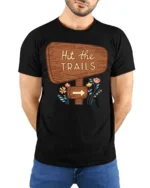 Hit The Trails Hiking Adventure Nature Graphic Tee Tshirt - model wearing black tee with hands behind back