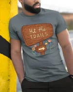 Hit The Trails Hiking Adventure Nature Graphic Tee Tshirt - model wearing grey tee, leaning on column