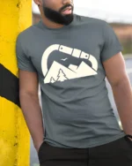 Carabiner Mountain Adventure Outdoor Hiking Graphic Tee Tshirt - model wearing grey tee, leaning on column