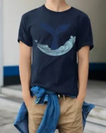 Whale Tail Ocean Wave Graphic Tee Minimal Marine Art Style - model wearing navy tee with hands in pockets