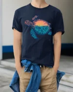 Sea Turtle Sunset Ocean Life Graphic Tee Coastal Aesthetic - model wearing navy tee with hands in pockets