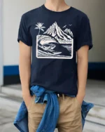 Surfing Iguana Mountain Wave Graphic Tee Tropical Adventure - model wearing navy tee with hands in pockets