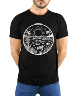 Ocean Sunset Marine Life Graphic Tee Coastal Nature Style - model wearing black tee with hands behind back