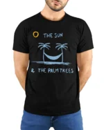 The Sun And Palm Trees Relax Graphic Tee Beach Chill Style - model wearing black tee with hands behind back